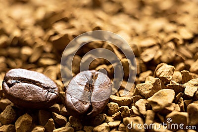 Beans of natural roasted coffee close-up lie on the granules of instant coffee. Ingredients of a fragrant invigorating drink, Stock Photo