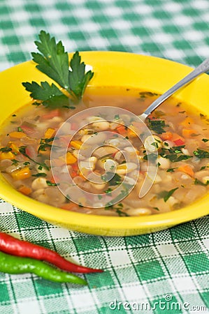 Beans soup with parsley leaf and peppers Stock Photo