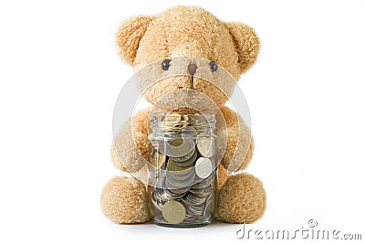 Bear doll hugging glass coins on white background isolated. Stock Photo