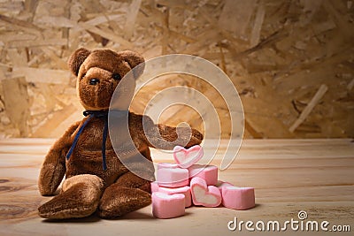 Bear doll with marshmallow heart. Stock Photo
