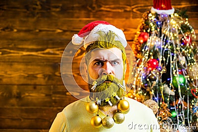 Beard with bauble. Santa in barbershop. Christmas or New Year barber shop concept. Christmas style for modern Santa. Stock Photo