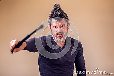 Bearded angry man with tonfa. People, emotions concept Stock Photo