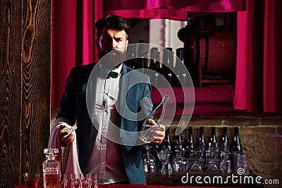 Bearded barmen, barkeeper or bartender in bar. Man with beard and mustache, vintage retro. Stock Photo