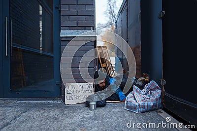 Bearded beggar sleeping on city street Stock Photo