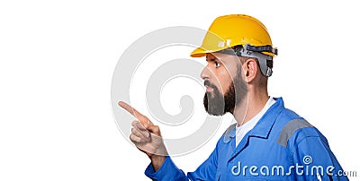 Bearded builder in hard hat, foreman or repairman in the yellow helmet pointing his finger in profile Portrait architect builder Stock Photo