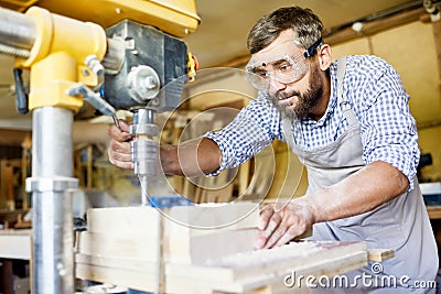 Bearded Carpenter Wrapped up in Work Stock Photo