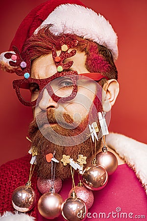 Bearded crazy Santa looking at the camera. Christmas santa wishes merry christmas. Bearded Santa Claus - close up Stock Photo