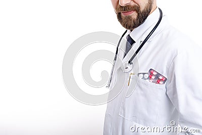 Bearded Doctor in Smock With Various Pills and Tablets in Pocket Stock Photo