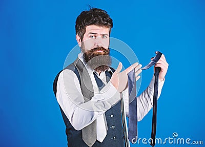 Bearded but elegant. Long bearded hipster choosing neckwear. Bearded man holding necktie. Cheerful man with unshaven Stock Photo
