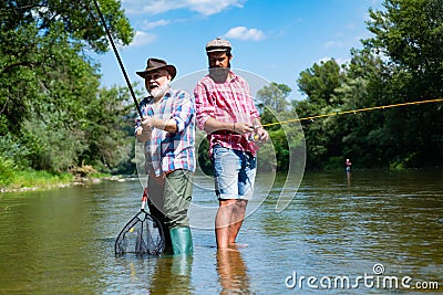 Bearded elegant men. Fisher fishing equipment. Fishing is fun. Man relaxing and fishing by lakeside. Pothunter. Fly fish Stock Photo