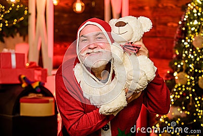 Bearded grandfather senior man celebrate christmas. Kind grandpa with teddy bear. Christmas decoration. Charity and Stock Photo