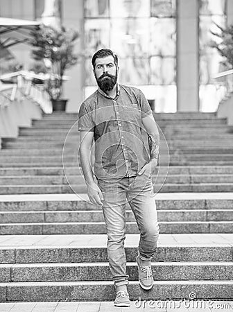bearded hipster walking downstairs. full length of hipster with beard. hipster man outdoor Stock Photo