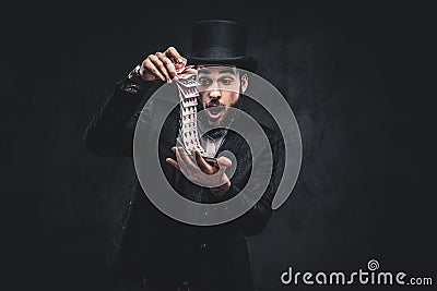 Magician showing trick with playing cards. Stock Photo