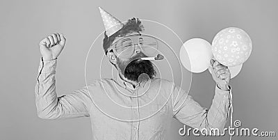 Bearded man in birthday cap and huge crazy glasses dancing, party hard, fun time concept. Hipster with trimmed beard and Stock Photo