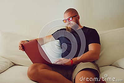 Bearded Man with blue light blocking eye glasses yellow amber lens Stock Photo