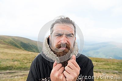 Bearded man, brutal caucasian hipster with moustache cold on mountain Stock Photo