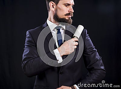 Bearded man in dark suit holds sticky brush for cleaning Stock Photo