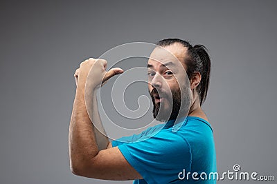 Bearded man with his arms up and thumbs up Stock Photo