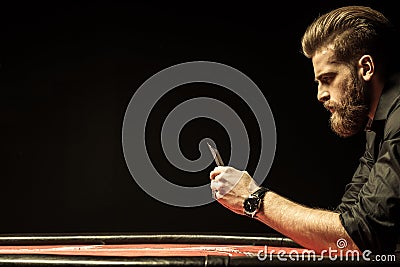 Bearded man holding poker cards on black Stock Photo