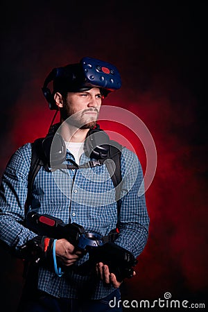 Bearded man holding vr shooter, looking side Stock Photo