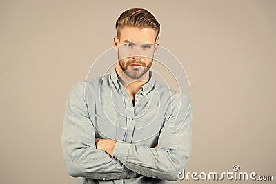 Bearded man keep arms crossed on grey background. Macho with serious face. Tired after everyday work. Office dress code Stock Photo