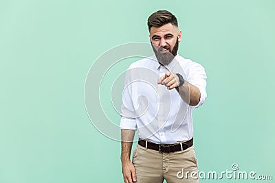 The bearded man pointing finger at camera and mockery over someone. Stock Photo