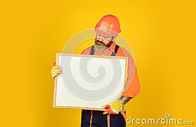 Bearded man repairman builder. Plan repair works. Visual outline. Architect showing project. Professional repairman Stock Photo