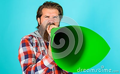 Bearded man screaming in loudspeaker or megaphone. Freedom of speech. Announcing or spreading news. Stock Photo