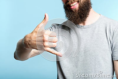 Bearded man show phone call gesture shaka sign Stock Photo