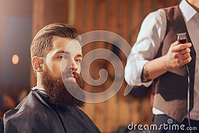 Bearded man sitting in the barbershop Stock Photo