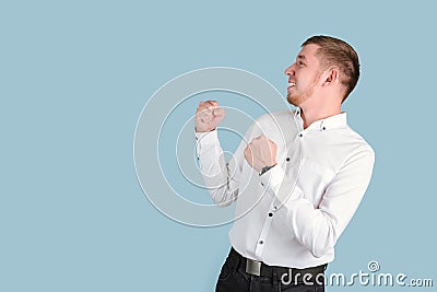 A bearded man smiles and holds his fists in front of him pretending that he will fight and defend himself, copyspace Stock Photo