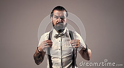 bearded man in suspenders. brutal guy wear bow tie. elegant male fashion look. handsome hipster in formal wear. party Stock Photo
