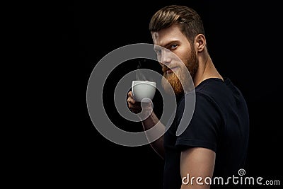 Bearded man is tasting coffee Stock Photo