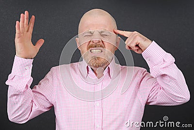 Bearded man is very emotionally stressed holding his hands near his head Stock Photo