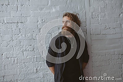 Bearded man wearing gray hoodie standing Stock Photo