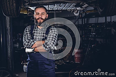 Bearded mechanical male in a garage. Stock Photo