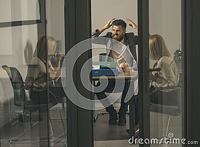 Bearded man shout with anger at woman in office. Bearded man and financier discuss company budget and money crisis Stock Photo