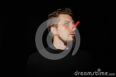 Bearded prankster with clothespin on nose. Funny joke concept Stock Photo