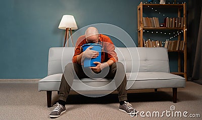 Bearded sick man suffering from sick stomach and vomiting at home. Stock Photo