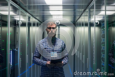 Bearded IT specialist setting servers in data center Stock Photo