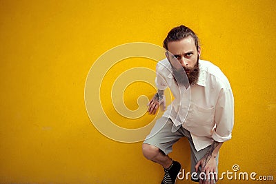 Bearded and tattooed man posing in fashion style Stock Photo