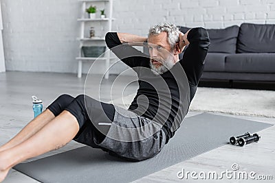 bearded and tattooed man working out Stock Photo