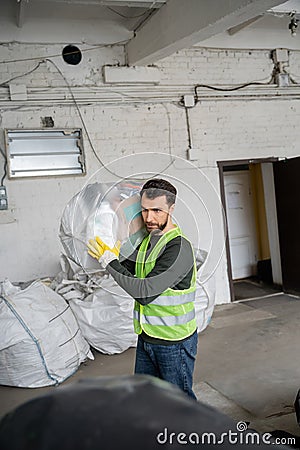 Bearded worker in protective vest and Stock Photo