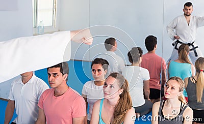 Beardy coach is showing new martial moves to adults Stock Photo