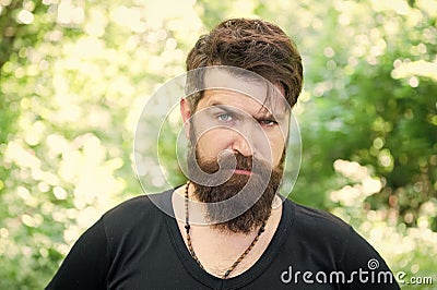 Beardy hipster. Brutal hipster on summer landscape. Bearded man in trendy hipster style outdoor. Caucasian hipster with Stock Photo