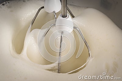 Beaten egg whites with a modern kitchen mixer used to beat the e Stock Photo