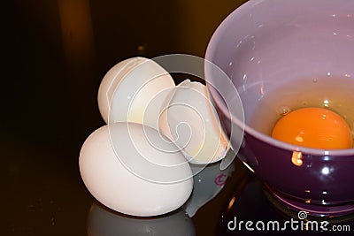Beaten eggs in bowl with salt Stock Photo