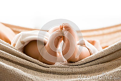 A BEATIFUL BABY GIRL IN A HAMMOCK SHOWING HER FEETS Stock Photo