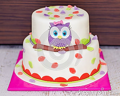 Beatiful Colorful Cake wit Baby Owl on a Branch with leaves Stock Photo