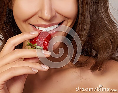 Beatiful girl with Perfect smile eat red strawberry white teeth and healthy food Stock Photo
